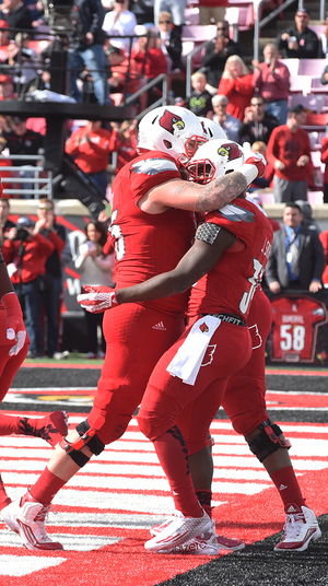 Louisville celebrates one of its several scores against the Orange in the Cardinals' 41-17 win over SU.