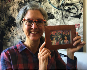 Hanna Richardson, Posse mentor, poses with a photo of her first posse from Atlanta that graduated with the class of 2016. 