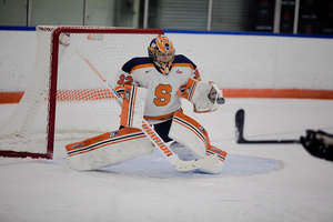 Syracuse goalkeeper Ady Cohen blocks a puck shot at the goal.