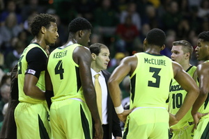 Freddie Gillespie (No. 33 on the left) huddles with his team.