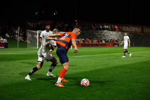 Syracuse's Nicholas Kaloukian fights for possession in Cardinal territory. The Orange tallied 19 shots but failed to find its game-winning third goal 