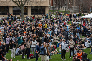 Syracuse University students wait for the solar eclipse on the quad. Once in a while, when the clouds moved out of the way, a cheering of excitement rolled over the Quad and heads started looking towards the sky.
