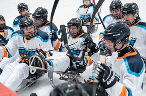 Players on Central New York Flyers, an adaptive recreational hockey team, sit in specially designed sleds. Sled hockey games have the same fundamental rules and scoring guidelines as ice hockey. 