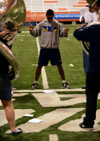 Morgan Edwards, an SU junior, instructs the sousaphone section.