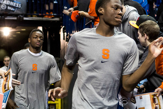 Freshman Tyler Roberson leads Grant out of the tunnel before the start of the game.