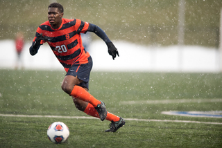 SU defender Kamal Miller runs through the wet conditions.