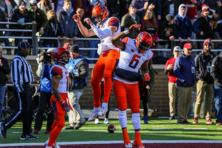 Eric Dungey and Ravian Pierce celebrate in the back of the end zone after an SU touchdown.