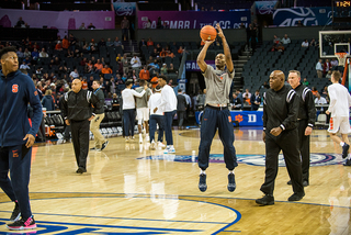 Jalen Carey warms up as junior guard Tyus Battle watches because of a back bruise keeping him out. 