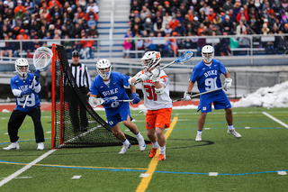 Jacob Buttermore feeds from behind the cage. 