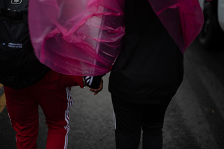 Despite the wind and rain, this couple held hands as they protested.